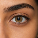 Bella Cova coloured contact lens shown on a dark brown eye