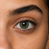 Fresh Lady Breeze Green coloured contact lens shown on a dark brown eye