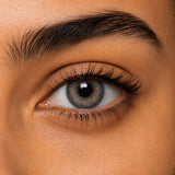Fresh Lady Lolite on a dark brown Egyptian eye — grey-blue with a warm gold centre