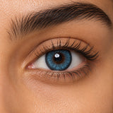 Fresh Lady Sky Blue coloured contact lens shown on a dark brown eye