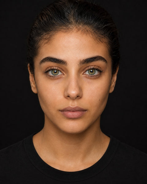 An obviously coloured grey lens shown on a dark brown Egyptian eye
