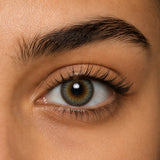 Urban Layer Breeze Gray coloured contact lens shown on a dark brown eye