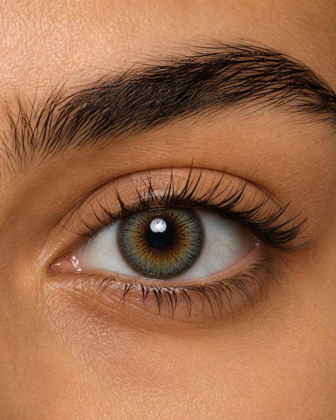 Urban Layer Breeze Gray coloured contact lens shown on a dark brown eye