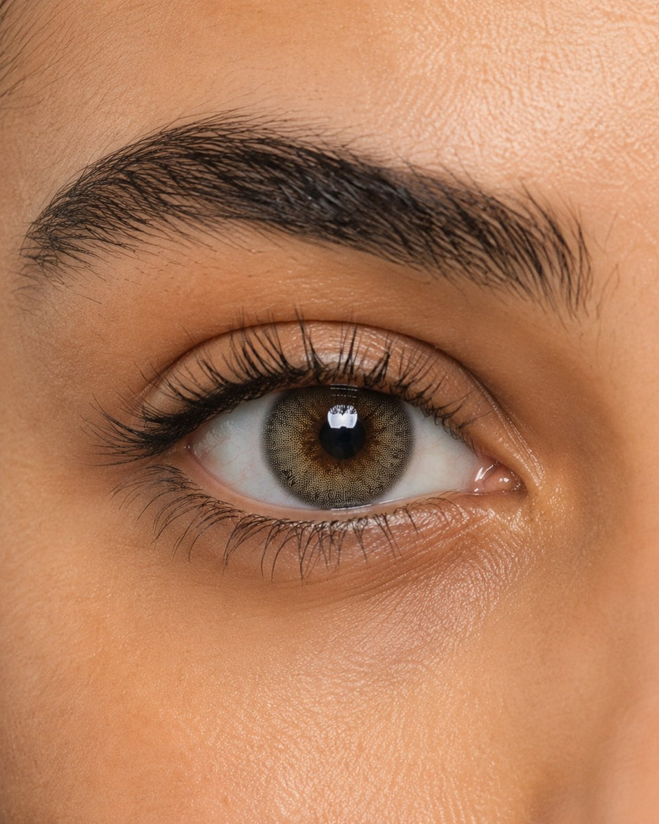 Urban Layer Cloud Gray coloured contact lens shown on a dark brown eye