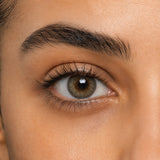 Urban Layer Cloud Gray coloured contact lens shown on a dark brown eye